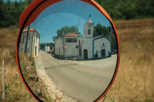 Church and house reflected in a street mirror photo