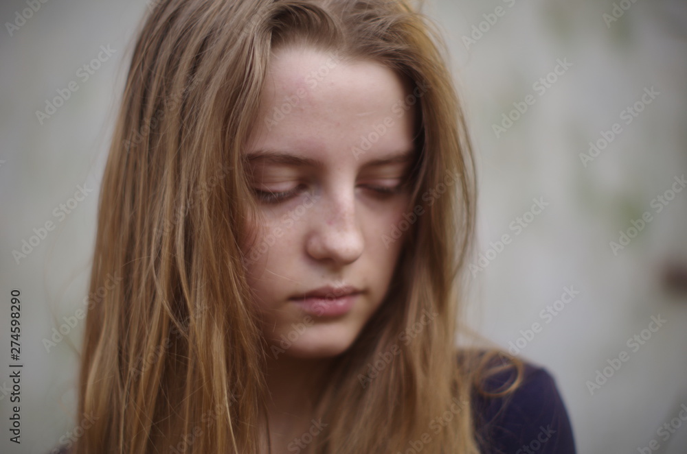 beautiful young blonde with long flowing hair on a blurry background beautiful young blonde with long flowing hair on a blurry background