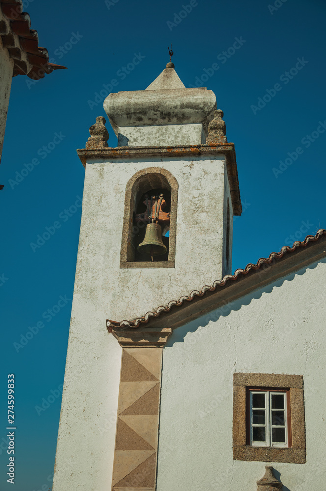Old church steeple with bell in baroque style at Marvao