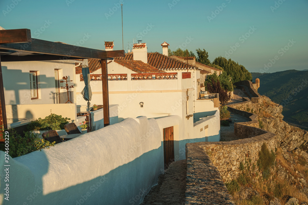 Wall and white old houses over rocky ridge in Marvao