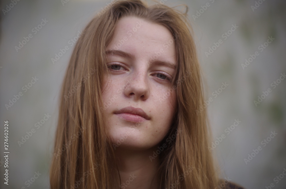 beautiful young blonde with long flowing hair on a blurry background beautiful young blonde with long flowing hair on a blurry background