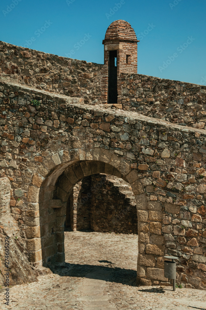 Arched gateway in the city outer wall made of rough stone