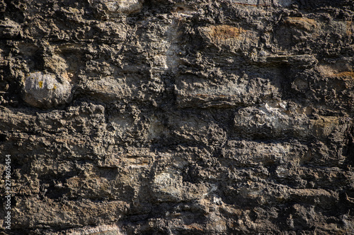 Old rough weathered stone wall texture