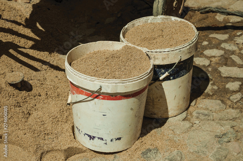 Plastic buckets with sand in construction site