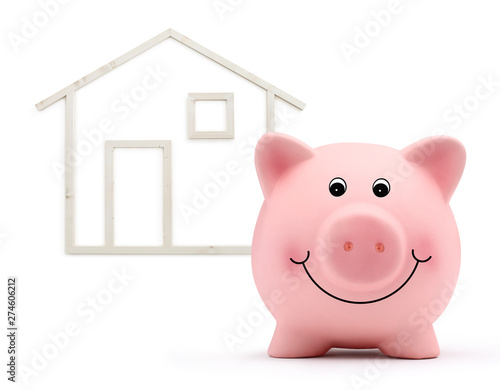 piggy bank with wood house shape isolated on white background  real estate and savings purchase concept