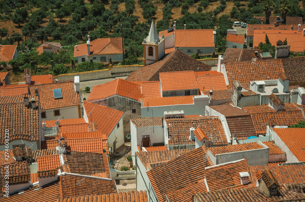 Cityscape with many rooftops, steeple and fields Cityscape with many rooftops, steeple and fields