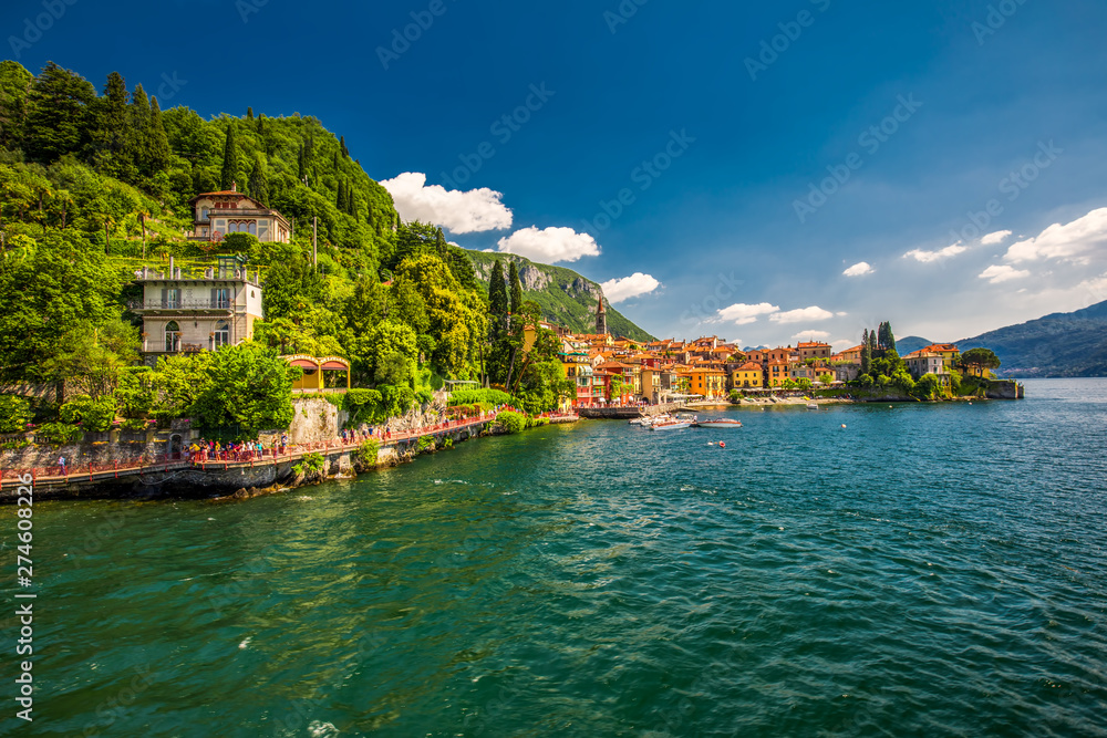 VARENNA, ITALY - June 1, 2019 - Varenna old town with the mountains in the background, Italy, Europe