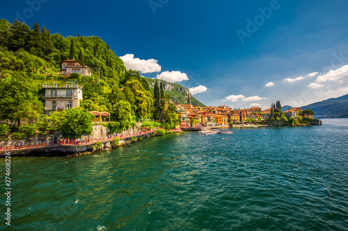 VARENNA, ITALY - June 1, 2019 - Varenna old town with the mountains in the background, Italy, Europe
