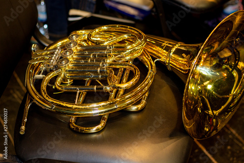 French horn lying on the chair.