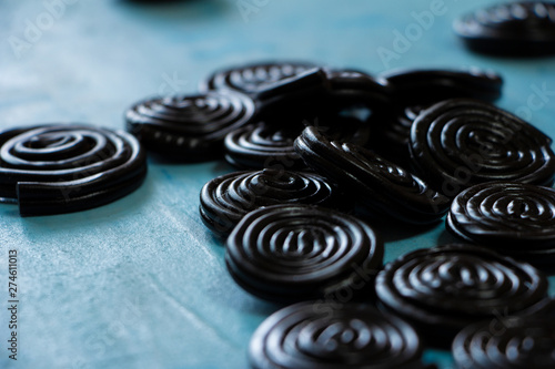 Detail of licorice candy spirals on blue background