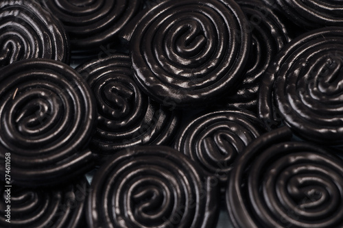 Detail of licorice candy spirals on blue background