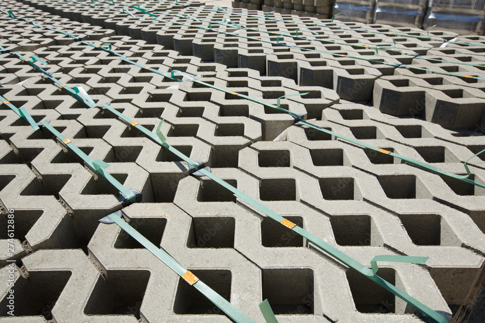 Fototapeta premium Concrete mesh stone for paving eco-friendly parking with grass. Warehouse paving.