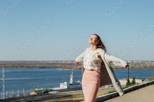 A young girl walks on the embankment of the city bay. © Julia Kiseleva