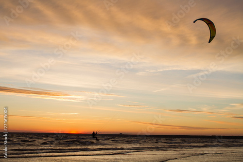 Kiter rides on the Gulf of Finland at sunset
