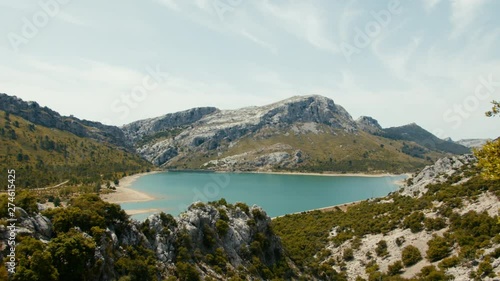 Mallorca, Serra De Tramuntana, slow panning left shot over mountain peeks and turquoise colored lake World Heritage Site by UNESCO photo