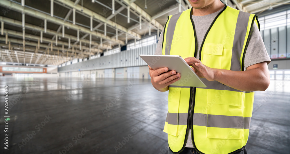 worker hand holding pad for check order pick time in empty warehouse worker hand holding pad for check order pick time in empty warehouse