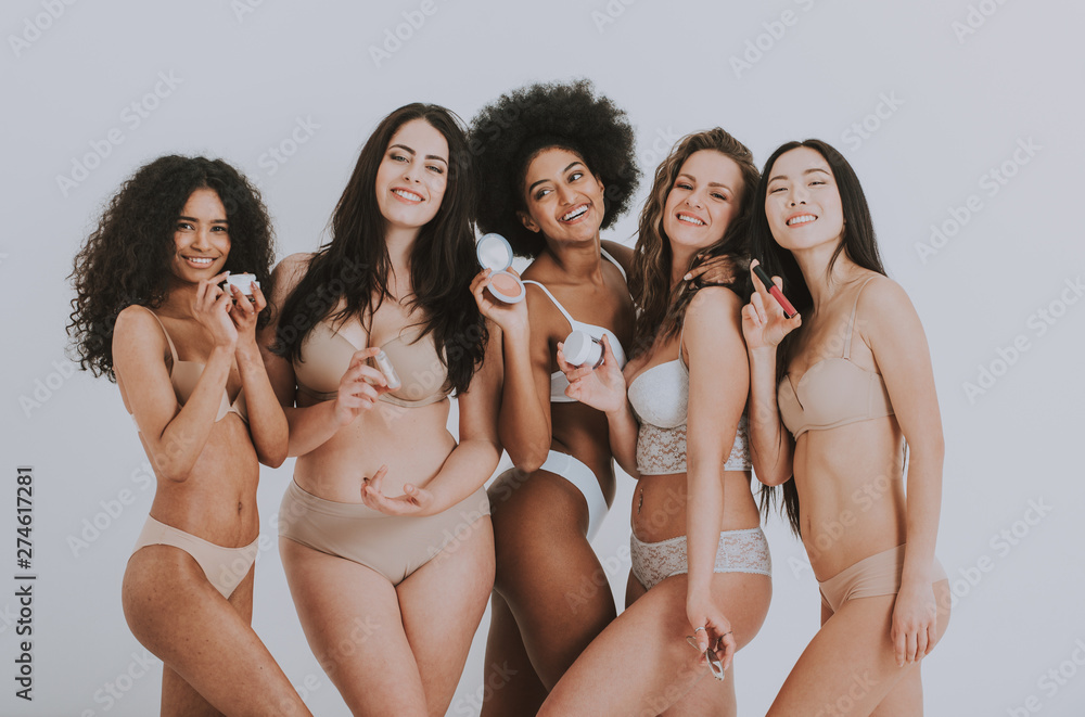 Fototapeta premium Group of women with different body and ethnicity posing together to show the woman power and strength. Curvy and skinny kind of female body concept