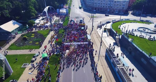 Aerial shot of marathon runners on asphalt road
