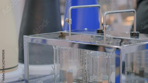 Pharmaceutical testing equipment - automatic tablet disintegration and dissolution apparatus with two basket at pharmacy factory or exhibition. Pharma industry, medicine and science concept