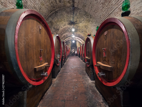 Oak barrels in an old underground wine cellar.