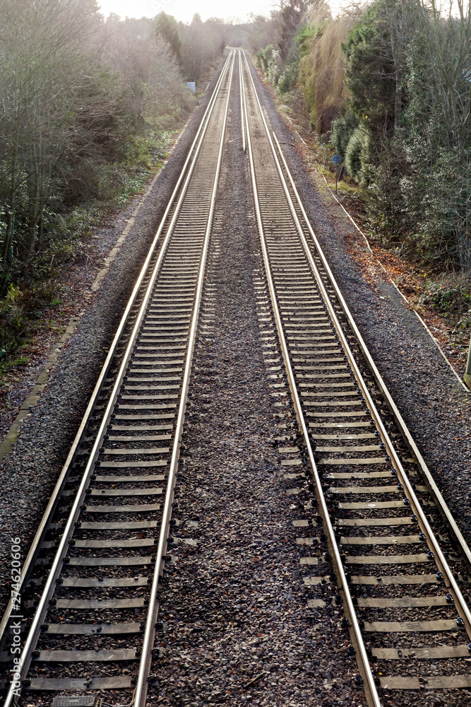 Railway lines pair recede into distance Railway lines pair recede into distance