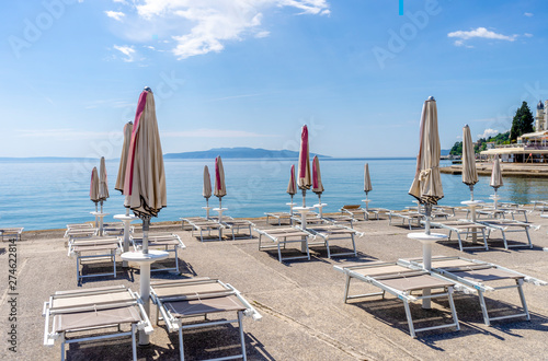 Beach with umbrellas and sun beds, ready for the summer. Croatia Opatija.