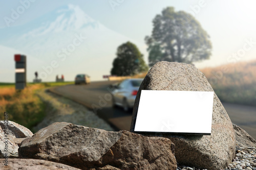 Bilbord reklamowy, biała tablica na skałach, na drodze w góry.