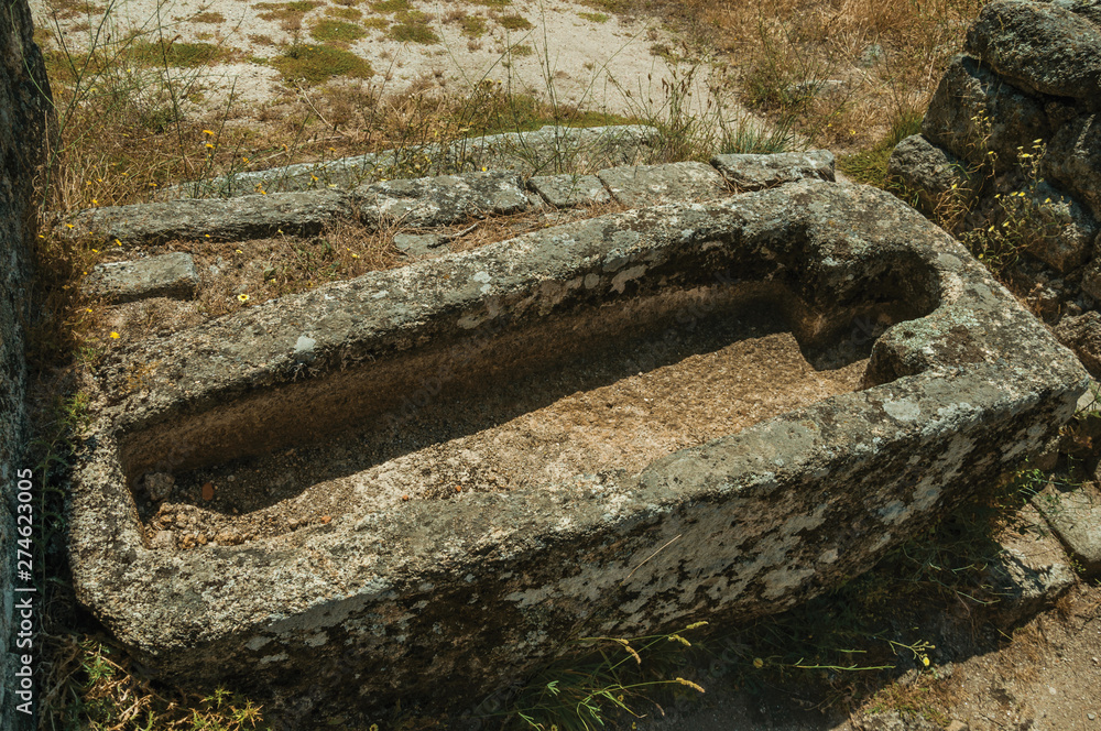 Fototapeta premium Ancient tombs for child and adult carved in stone near Monsanto