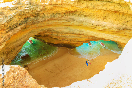 Algarve coast, Portugal. Aerial view of most impressive sea caves in Europe. Benagil Cave with boat trips leading to visit the caves from Praia de Benagil. Algar de Benagil is only accessible by sea. photo