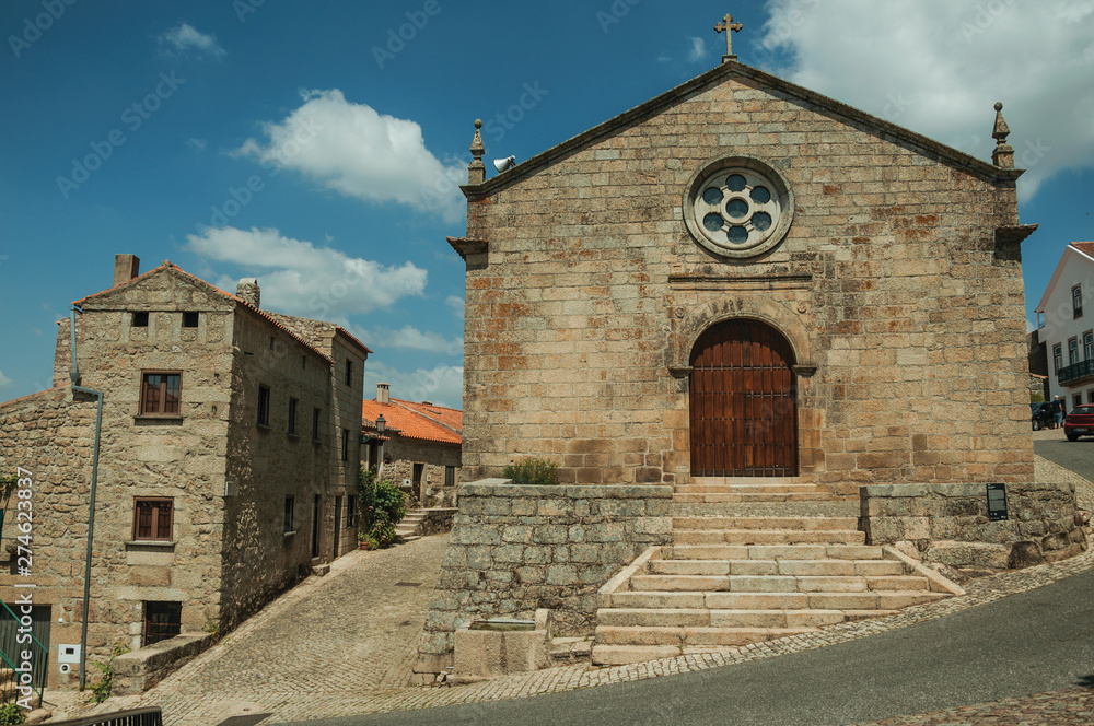 Medieval church facade with stone wall at Monsanto