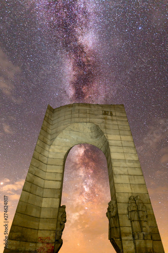 The Arch of Freedom monument Purple Milky way falling stars photo