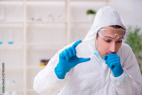 Young male chemist working in the lab 