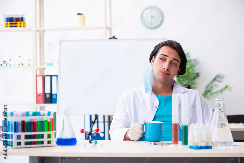 Young male chemist working in the lab Young male chemist working in the lab