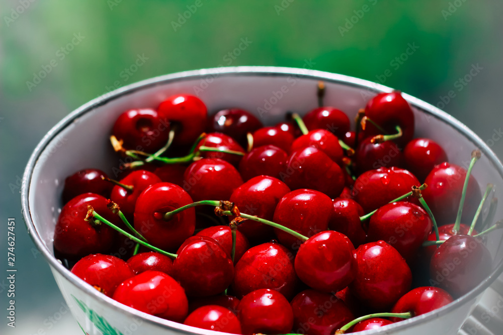 Fresh and beautiful red cherries in white dishes. Seasonal berries and healthy eating Fresh and beautiful red cherries in white dishes. Seasonal berries and healthy eating