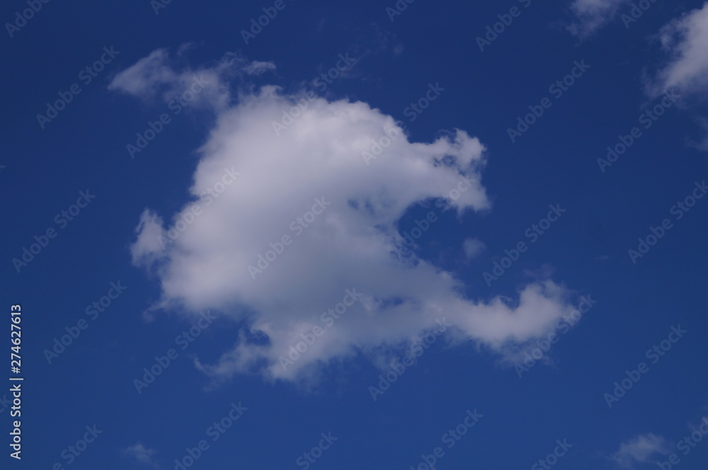 In summer, white clouds float across the blue sky. In summer, white clouds float across the blue sky.