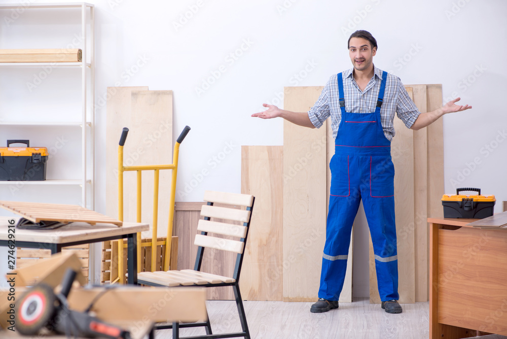Young male carpenter working indoors Young male carpenter working indoors