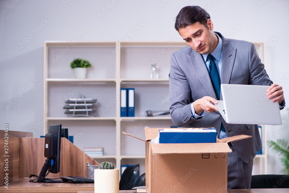 Young male employee being fired from his work Young male employee being fired from his work