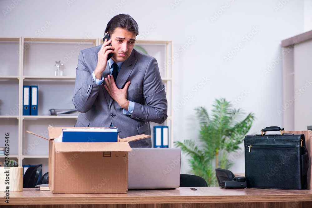 Young male employee being fired from his work Young male employee being fired from his work