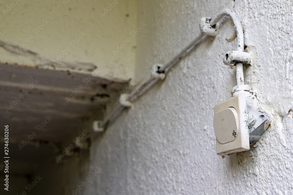Old electrical installation in a detached house. Light switch in the basement. Old electrical installation in a detached house. Light switch in the basement.