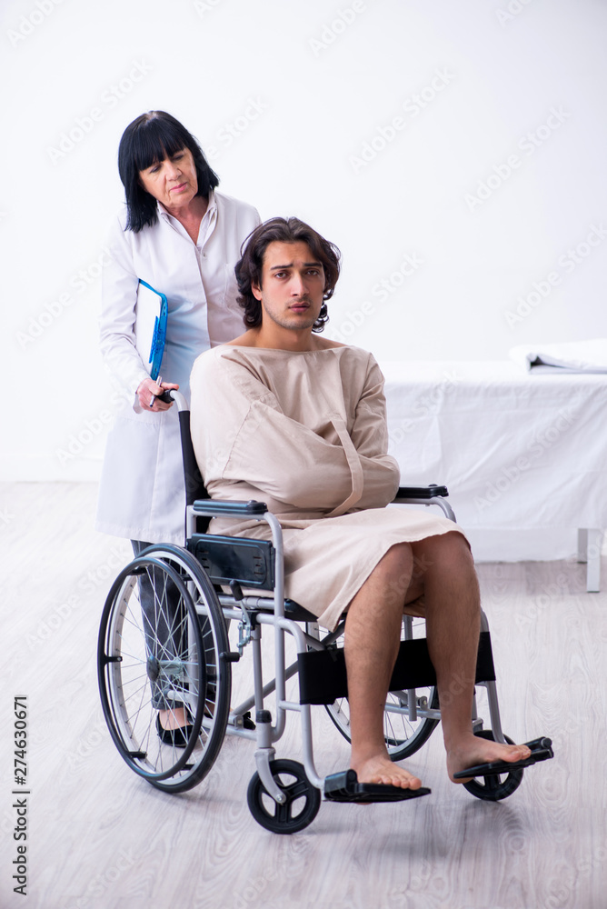 Old female psychiatrist visiting young male patient Old female psychiatrist visiting young male patient