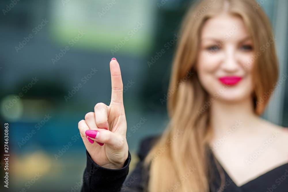 Successful business woman points finger at the place for text. Concept for business, office, save space, concept, marketing Successful business woman points finger at the place for text. Concept for business, office, save space, concept, marketing