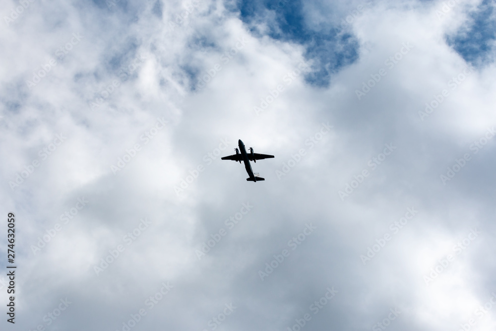 the plane flies across the blue sky the plane flies across the blue sky