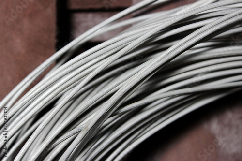 a coil of fechral thick refractory wire hangs in a warehouse of goods for ceramists. Frame of coiled nichrome wire for heating element photo