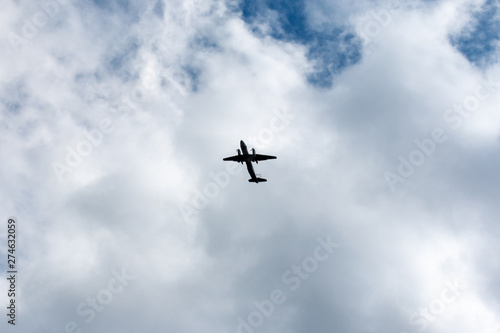 the plane flies across the blue sky © EvgenyPyatkov
