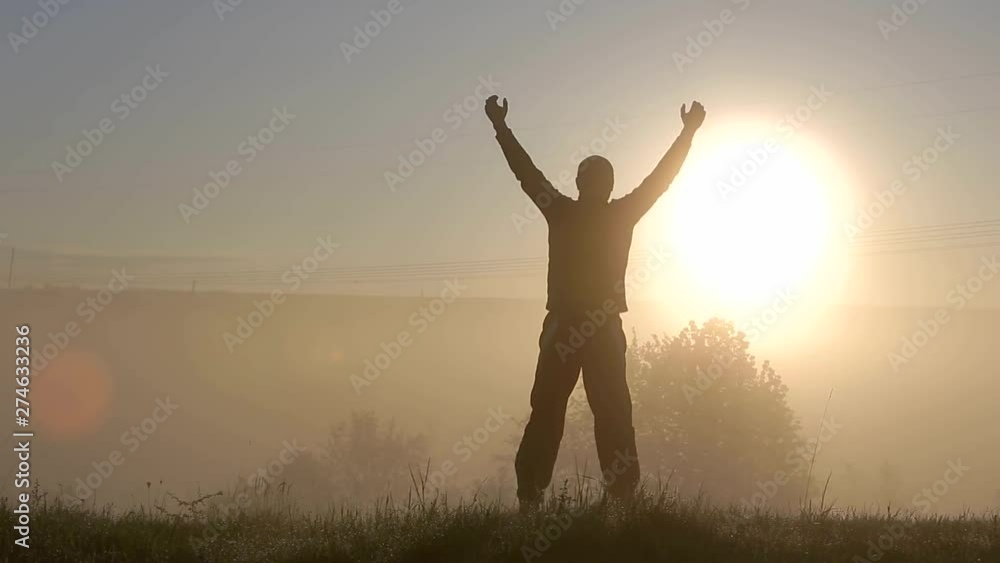Dark silhouette of a man having fun outdoors at sunrise. Dark silhouette of a man having fun outdoors at sunrise.