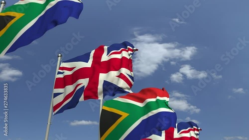 Row of waving flags of South Africa and the United Kingdom, loopable 3D animation photo