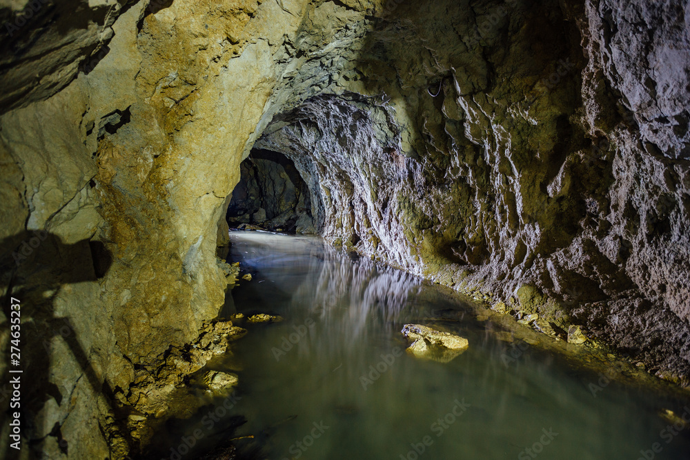 Dark creepy dirty flooded abandoned mine tunnel