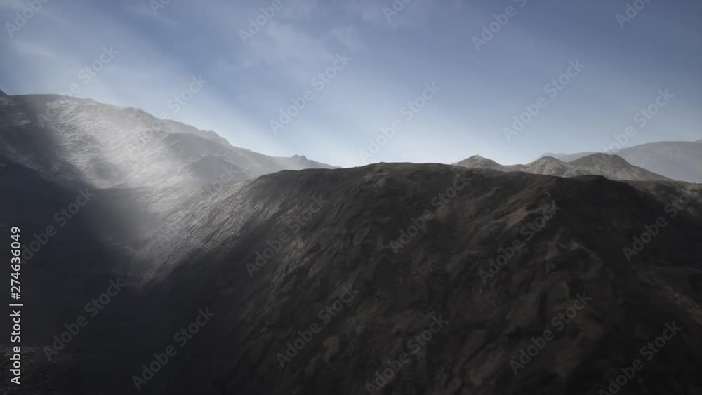 Sunlight rays over mountains in a valley Sunlight rays over mountains in a valley