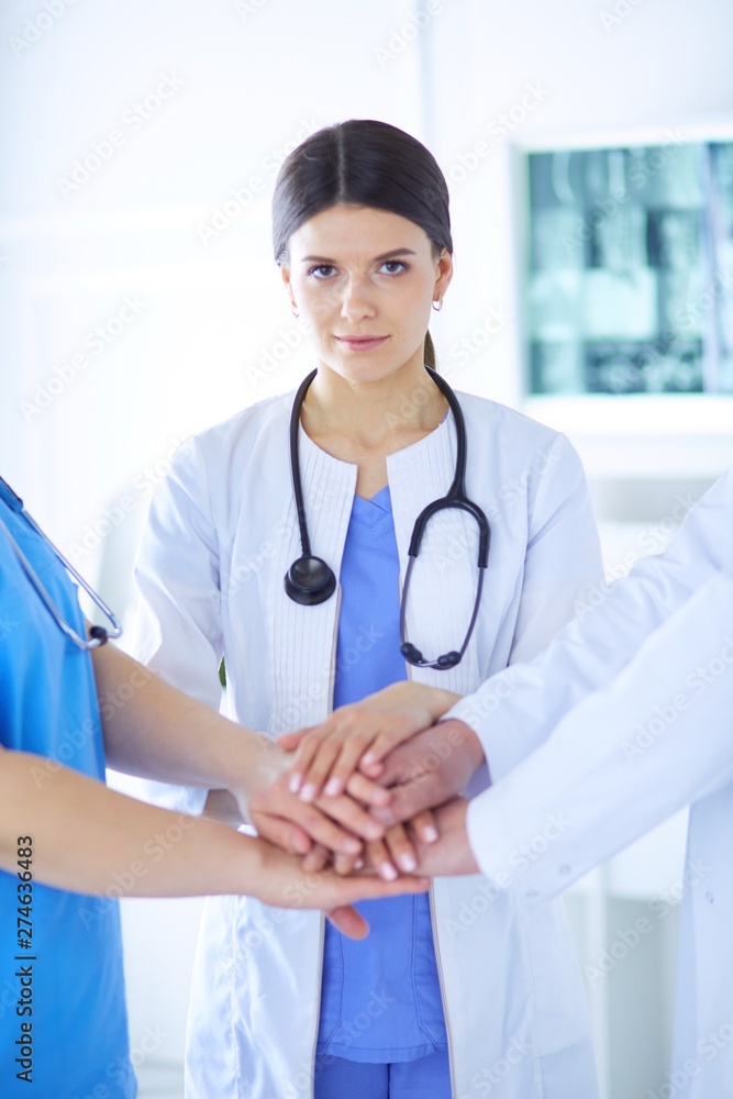 Group of doctors putting their hands together. Close-up Group of doctors putting their hands together. Close-up
