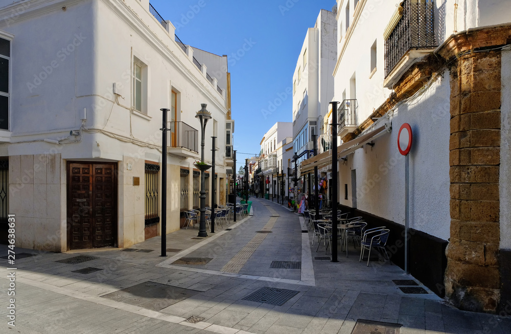 The narrow street of Rota city in sunny september day. Rota, Andalucia, Spain.
